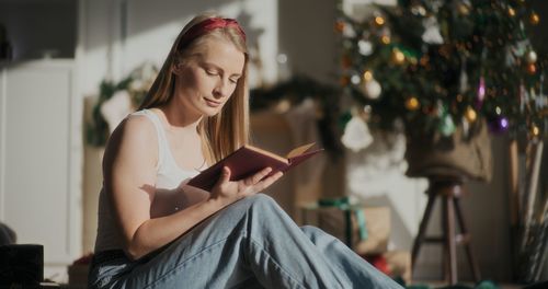 Young woman using mobile phone at home