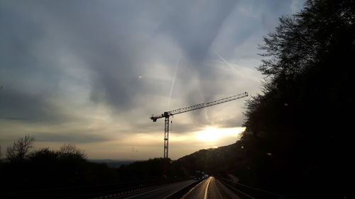 View of road against cloudy sky at sunset