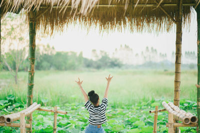 Rear view of boy standing on field