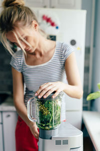 Midsection of woman holding food at home