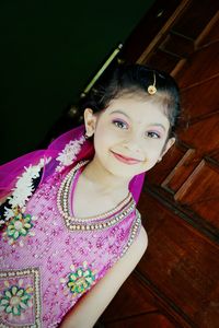 Portrait of smiling girl sitting outdoors