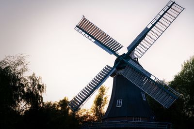 Low angle view of traditional windmill against clear sky
