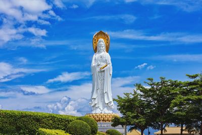 Low angle view of statue against blue sky