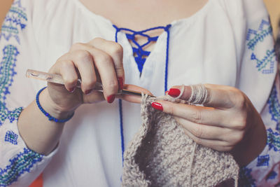 Midsection of woman knitting wool