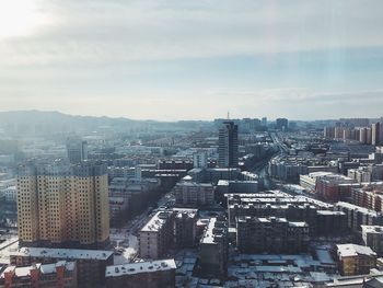 High angle view of buildings in city against sky