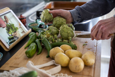 Senior man cutting vegetables for meal
