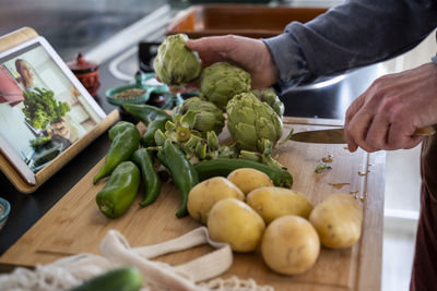 Senior man cutting vegetables for meal