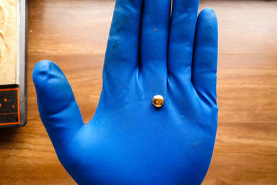 Close-up of man on blue wooden floor