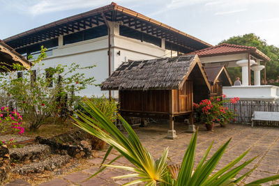 House by building against sky