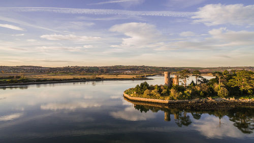 Castle by river against sky