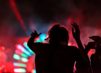 Rear view of man enjoying at music concert