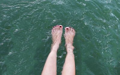 Low section of person legs in sea