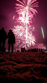 Low angle view of fireworks at night