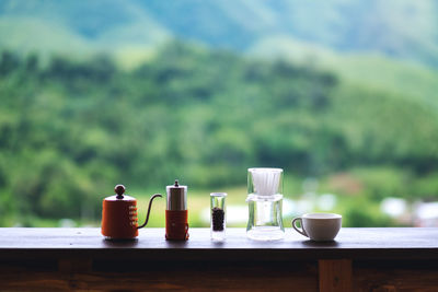 A set of coffee drip equipment with blurred nature background