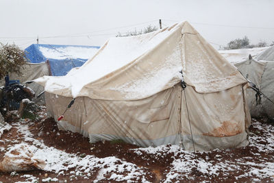 Syrian refugee tents covered with heavy snow.