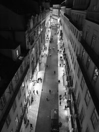 High angle view of people on road amidst buildings in city