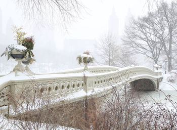 Bow bridge over lake at central park during winter
