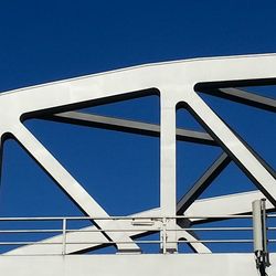 Low angle view of bridge against clear blue sky
