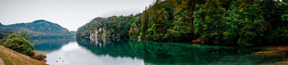 Panoramic view of lake and trees against sky