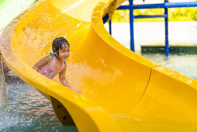 Full length of girl on swimming pool at playground