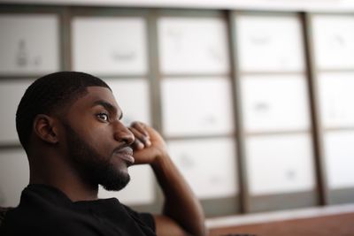 Thoughtful young man looking away