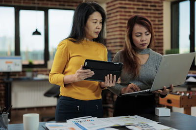 Business colleagues working over laptop at office