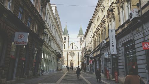 Road amidst buildings in city