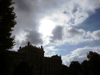 Low angle view of building against cloudy sky