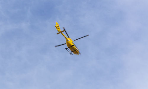 Low angle view of airplane flying against sky