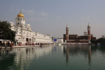 View of mosque and buildings in city against sky