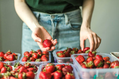 Midsection of woman with strawberries