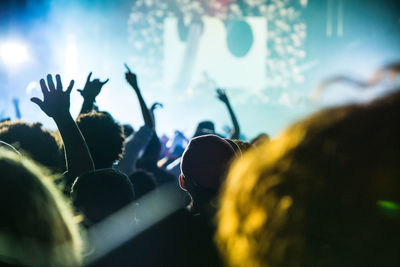 Close-up of people enjoying at music concert