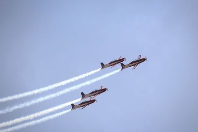 Low angle view of airshow against sky