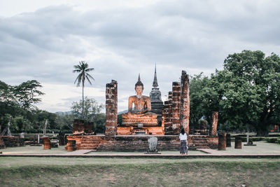 Statue of temple against cloudy sky