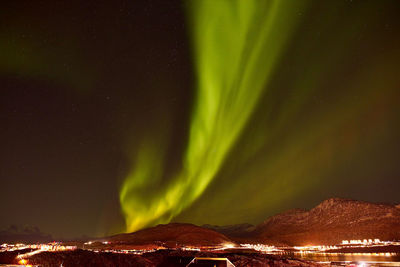 Scenic view of illuminated mountains against sky at night