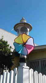 Low angle view of multi colored umbrella against sky