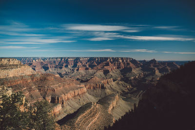 Scenic view of dramatic landscape against blue sky