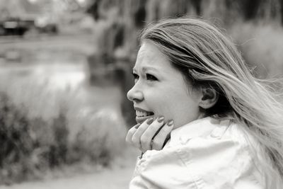 Portrait of smiling young woman looking away