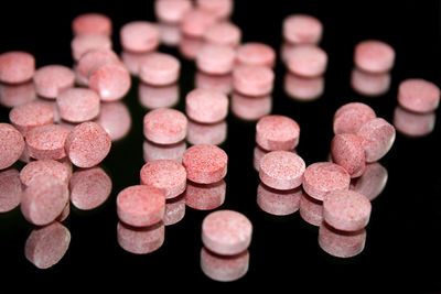 Close-up of pink medicines on black background