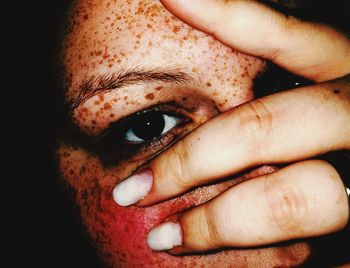 Close-up of portrait of woman covering face