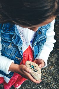 Close-up of girl holding rock