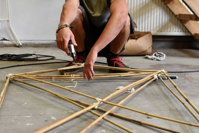 Low section of man fixing a frame