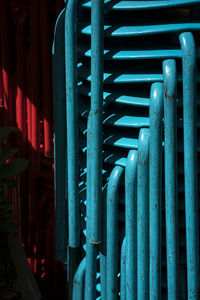 Close-up of stacked blue chairs