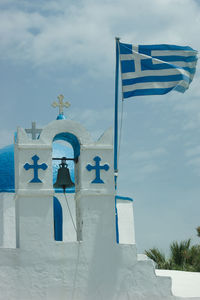 Low angle view of flag against blue sky