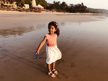 Full length of girl standing on beach