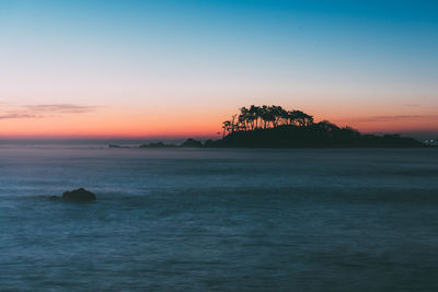 Scenic view of sea against sky at sunset