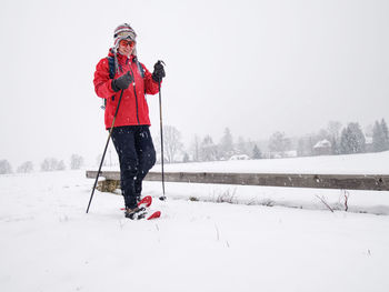 Person skiing on field during winter