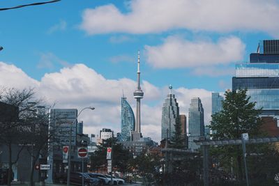 Buildings in city against cloudy sky