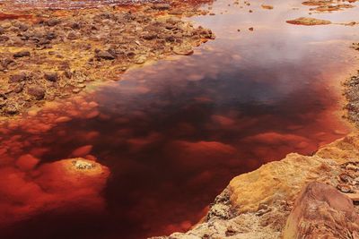 High angle view of rocks by sea against sky