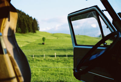 Scenic view of field seen through car windshield